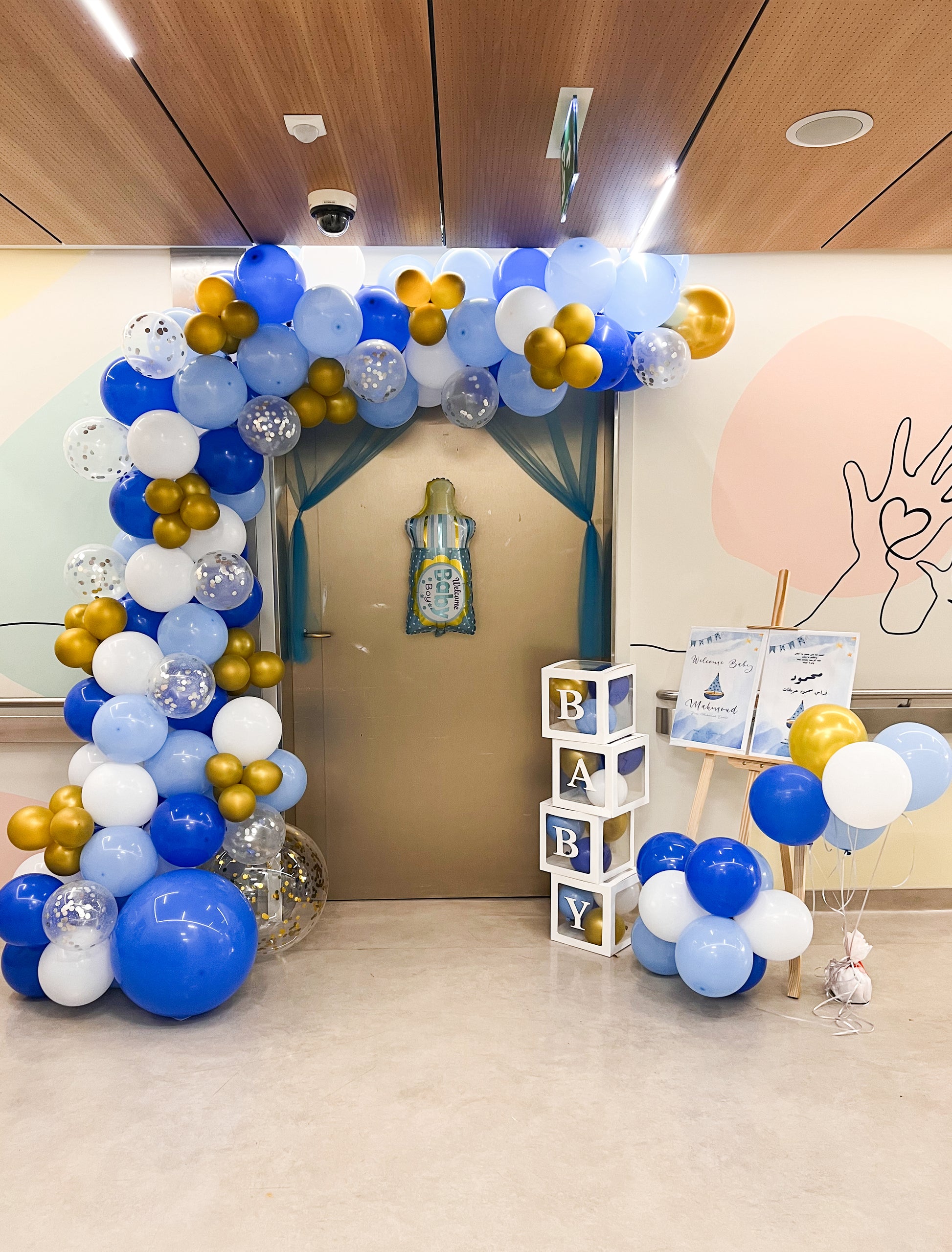 Welcome new baby with White and gold, light blue and dark blue balloon arch